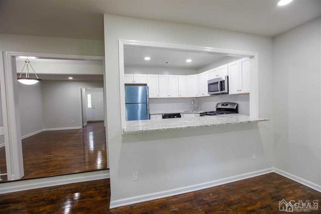 3004 Hana Road Edison, NJ 08817 - Photo 5 of 14 a kitchen with stainless steel appliances granite countertop a refrigerator and a stove top oven