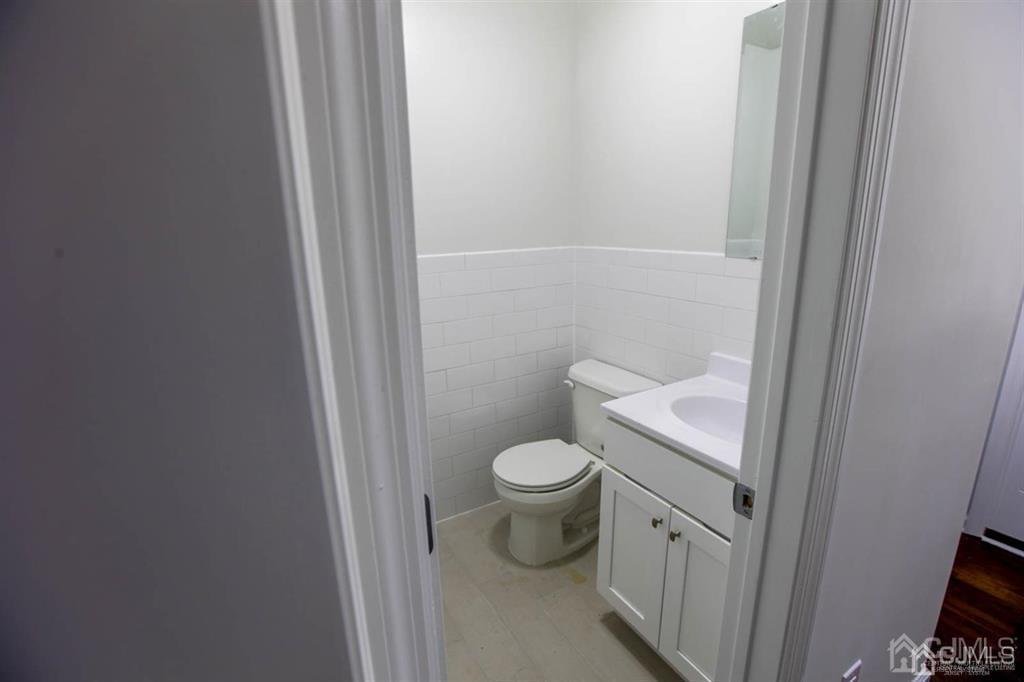 3004 Hana Road Edison, NJ 08817 - Photo 8 of 14 a white toilet sitting next to a shower