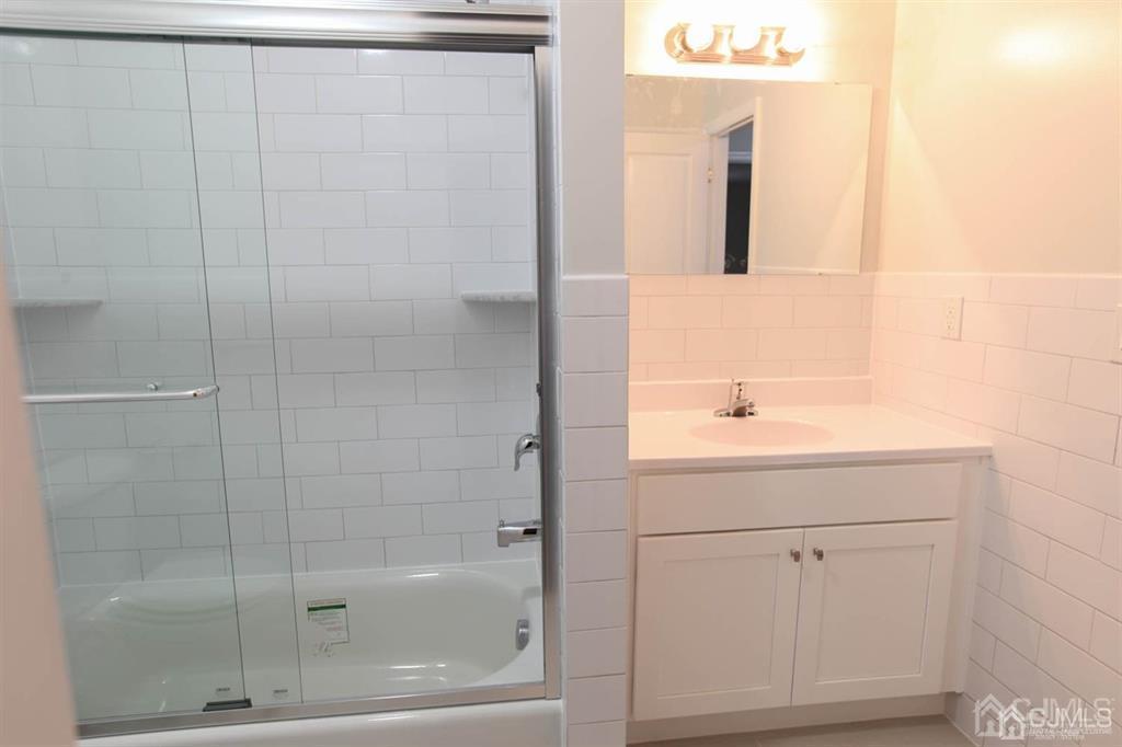 3004 Hana Road Edison, NJ 08817 - Photo 9 of 14 a bathroom with a shower and sink