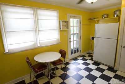 2260 Rumson Road Raleigh, NC 27610 - Photo 6 of 12 a bathroom with a sink and a refrigerator