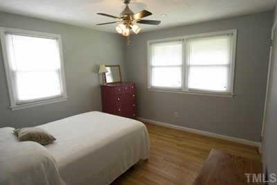 2260 Rumson Road Raleigh, NC 27610 - Photo 9 of 12 a bedroom with a bed dresser and a window