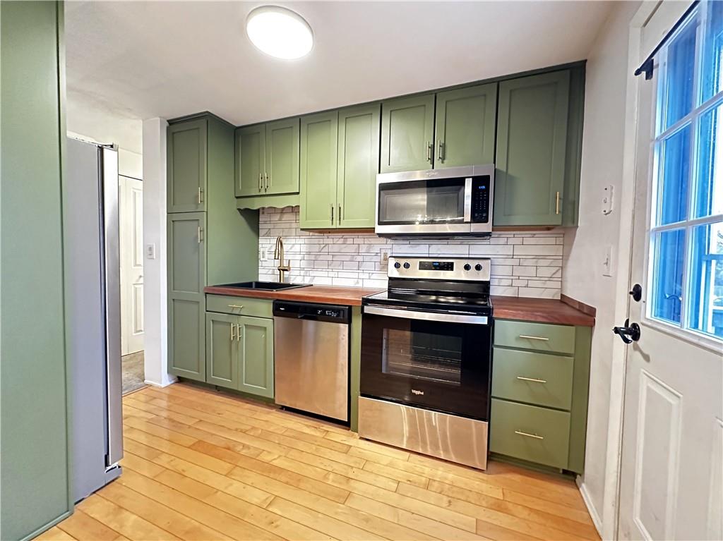 107 Fosterville Road Greensburg, PA 15601 - Photo 5 of 24 a kitchen with stainless steel appliances a stove a sink and a refrigerator