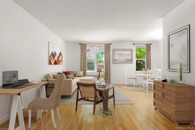 a living room with furniture wooden floor and a window