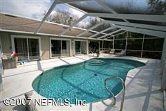 3333 Kings Road South St. Augustine, FL 32086 - Photo 2 of 11 a view of a backyard with table and chairs with wooden fence