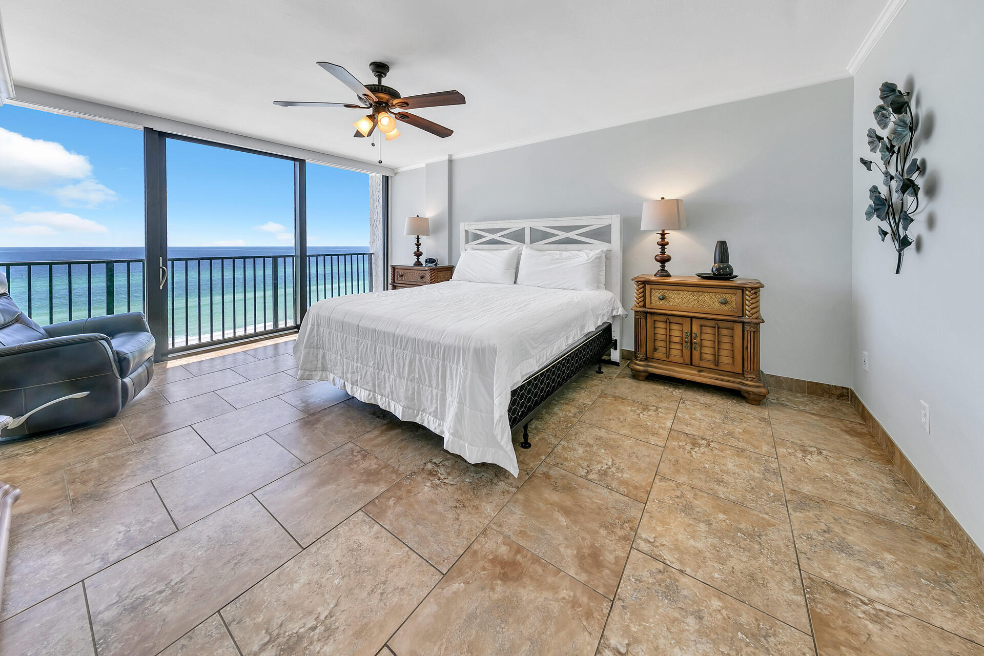 17351 Front Beach Road, Unit W602 Panama City Beach, FL 32413 - Photo 11 of 30 a bedroom with a bed and a chandelier