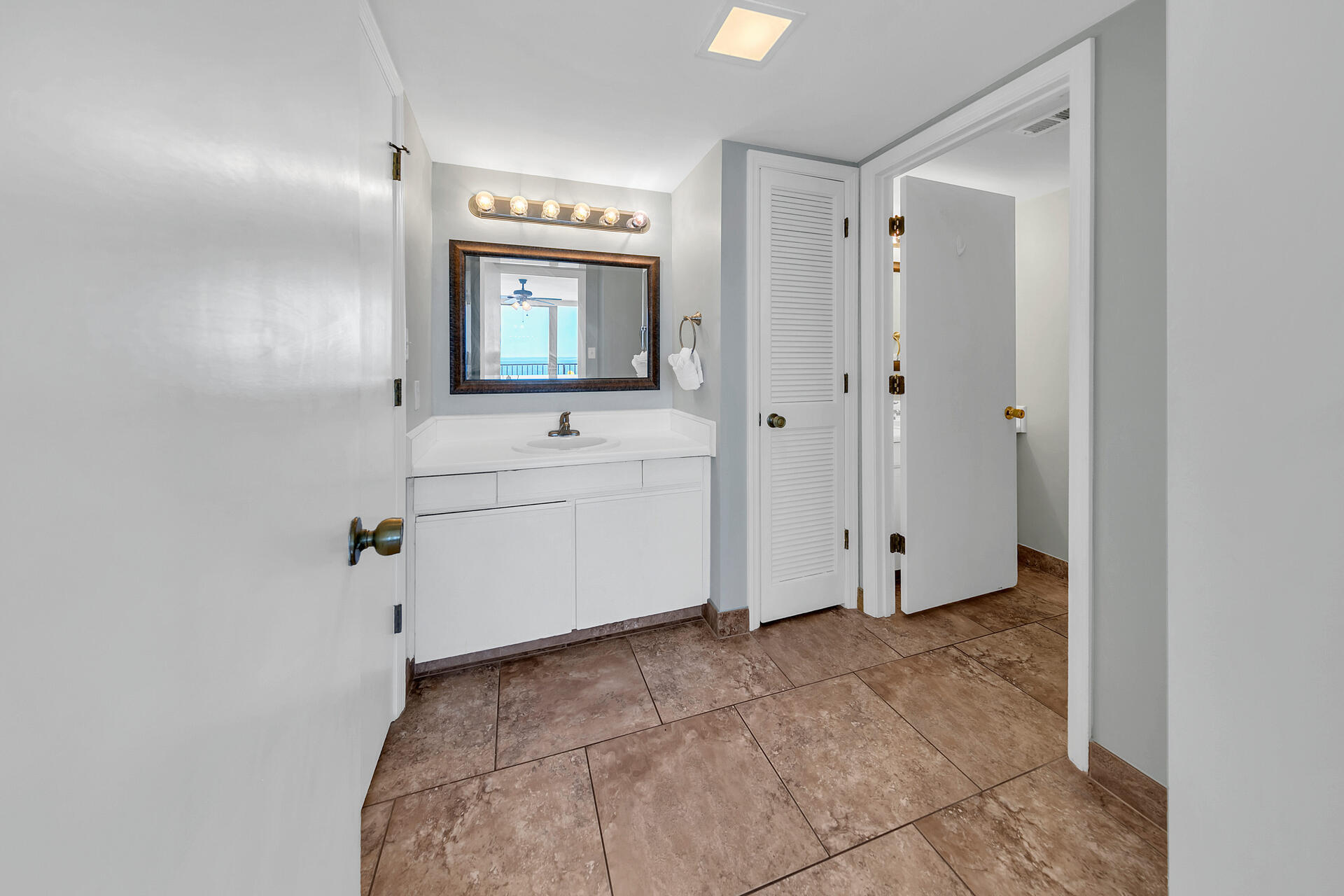 17351 Front Beach Road, Unit W602 Panama City Beach, FL 32413 - Photo 15 of 30 a view of kitchen with white cabinets and sink