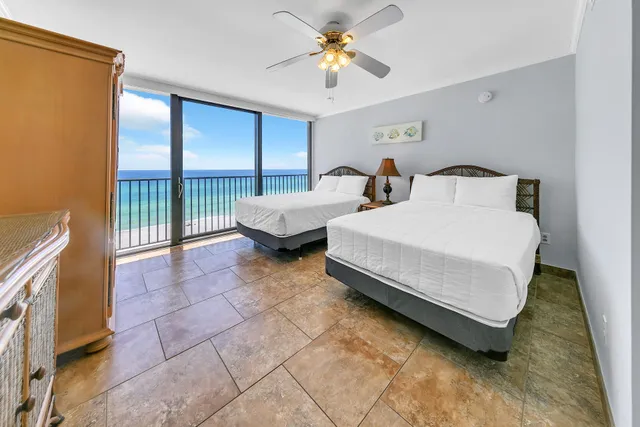 a spacious bedroom with a bed and a chandelier