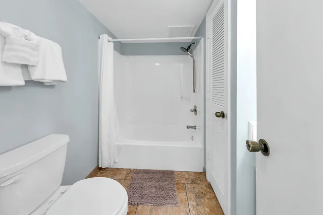 a bathroom with a toilet and a shower