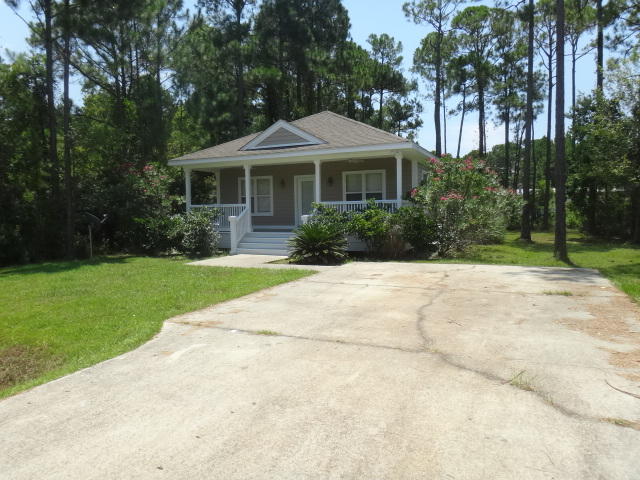 149 Mandy Circle Santa Rosa Beach, FL 32459 - Photo 1 of 13 a front view of a house with a yard