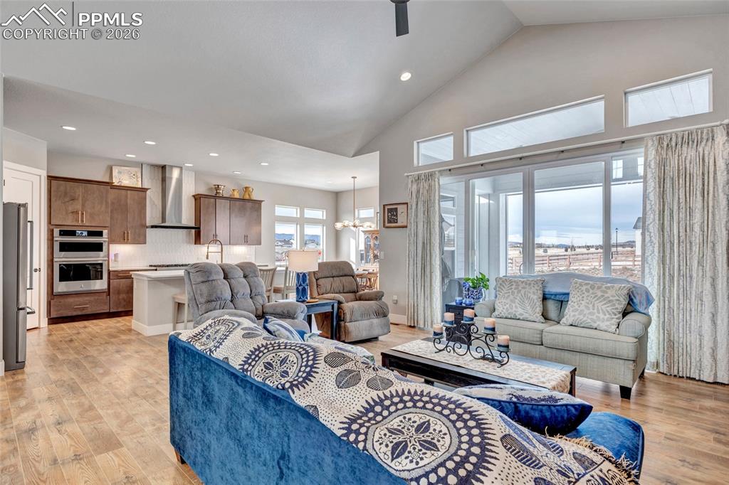 2402 Parma Court Colorado Springs, CO 80921 - Photo 11 of 45 a living room with furniture wooden floor and a large window