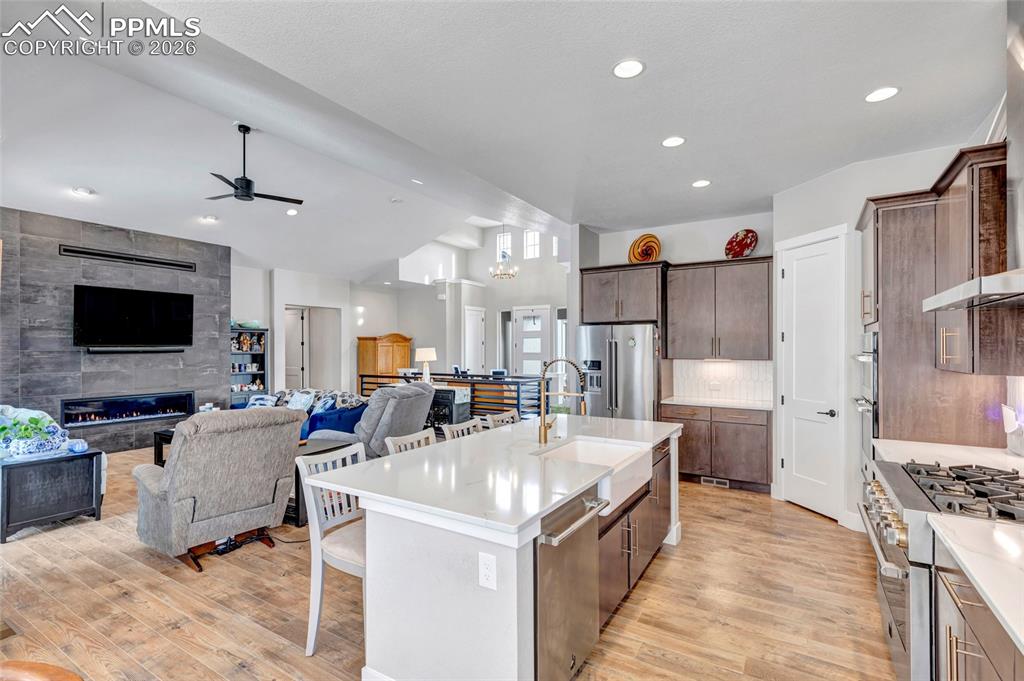 2402 Parma Court Colorado Springs, CO 80921 - Photo 17 of 45 a living room with stainless steel appliances furniture a flat screen tv and a view of kitchen