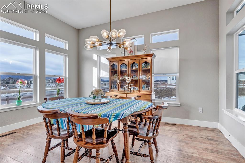 2402 Parma Court Colorado Springs, CO 80921 - Photo 19 of 45 a view of a dining room with furniture window and wooden floor
