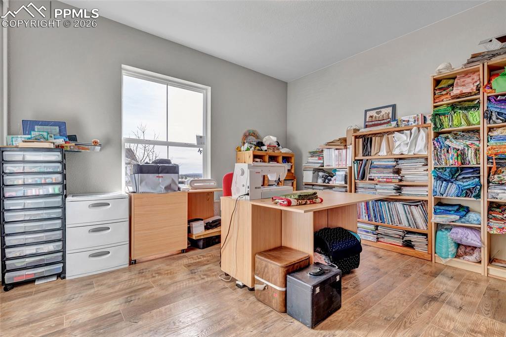 2402 Parma Court Colorado Springs, CO 80921 - Photo 21 of 45 a view of a workspace with furniture and a window