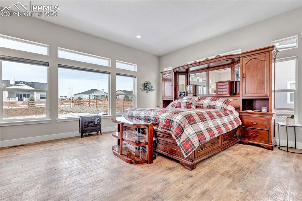 2402 Parma Court Colorado Springs, CO 80921 - Photo 23 of 45 a bed sitting in a spacious bedroom next to a window
