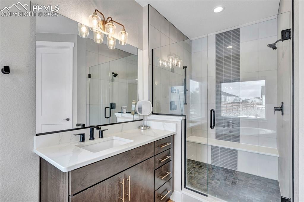2402 Parma Court Colorado Springs, CO 80921 - Photo 28 of 45 a bathroom with a sink double vanity and a mirror