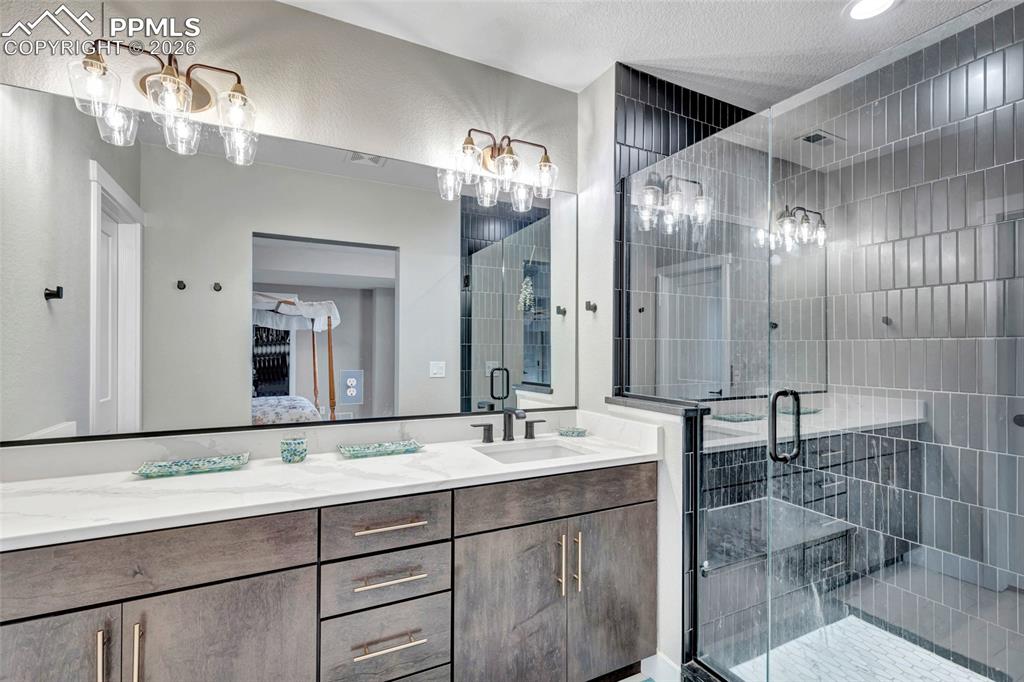 2402 Parma Court Colorado Springs, CO 80921 - Photo 29 of 45 a bathroom with double vanity sinks and a mirror