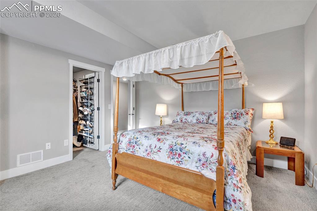 2402 Parma Court Colorado Springs, CO 80921 - Photo 34 of 45 a bedroom with a bed and a night stand