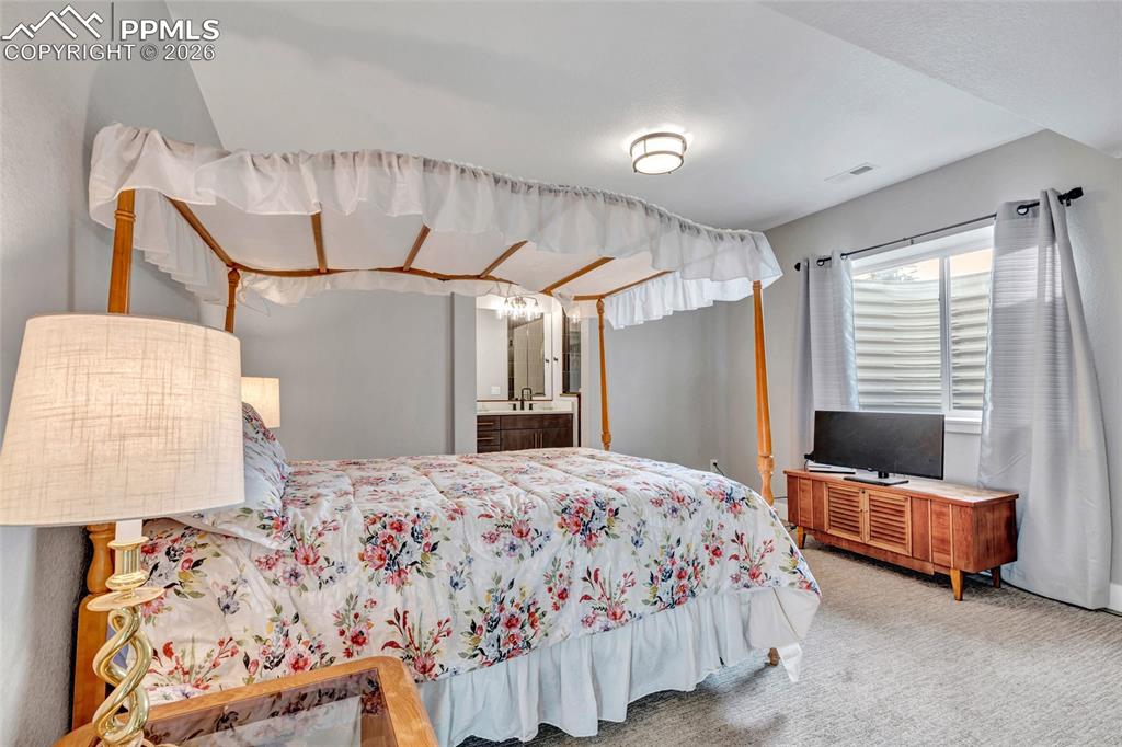 2402 Parma Court Colorado Springs, CO 80921 - Photo 35 of 45 a bedroom with bed and window