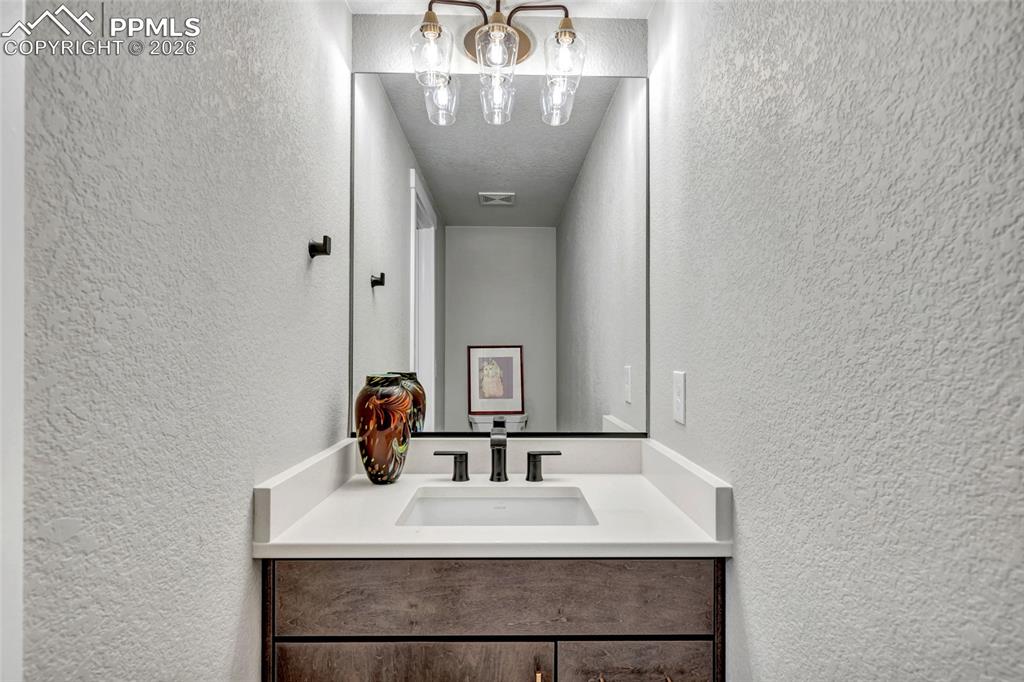 2402 Parma Court Colorado Springs, CO 80921 - Photo 36 of 45 a bathroom with a sink and a mirror