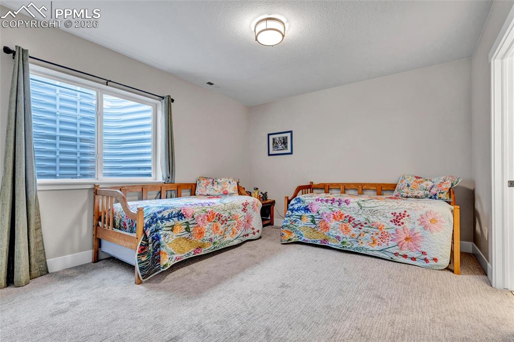 2402 Parma Court Colorado Springs, CO 80921 - Photo 37 of 45 a bedroom with a bed and a couch