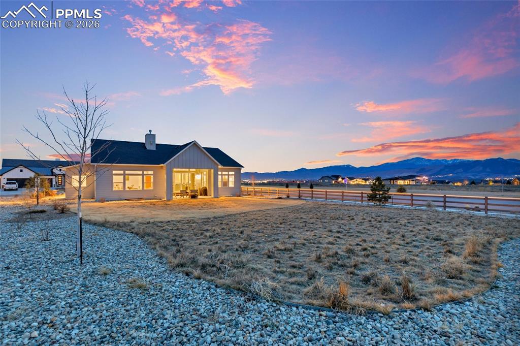 2402 Parma Court Colorado Springs, CO 80921 - Photo 43 of 45 a view of a large house with a yard and table and chairs