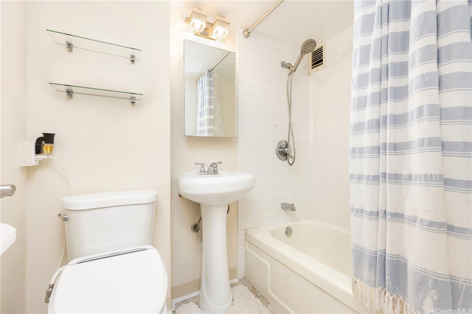 1415 Victoria Street, Unit 211 Honolulu, HI 96822 - Photo 8 of 21 a bathroom with a sink a toilet and shower