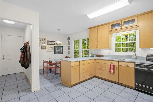 a kitchen with stainless steel appliances granite countertop a sink and a refrigerator