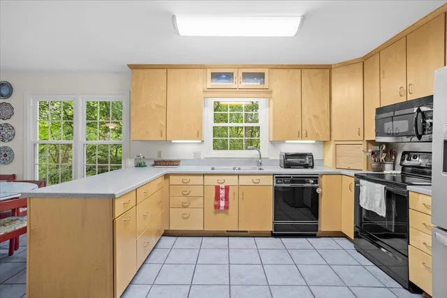 a kitchen with appliances cabinets and a sink