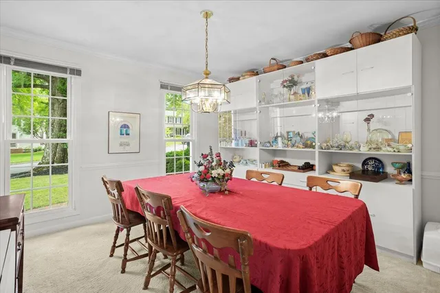 a view of a dining room with furniture and a chandelier