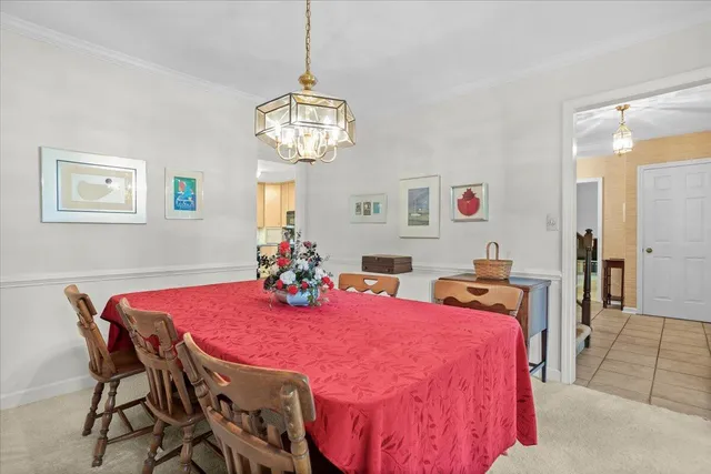a view of a dining room with furniture and chandelier