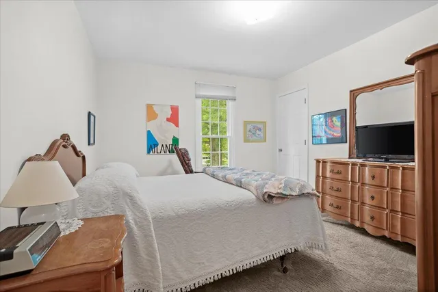 a bedroom with a bed and flat screen tv