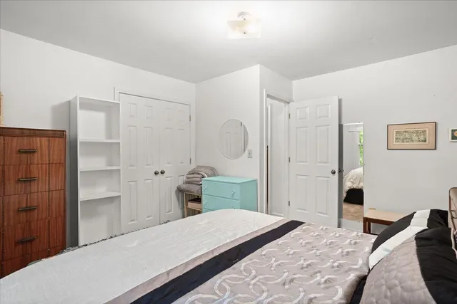 a bedroom with a bed and a dresser