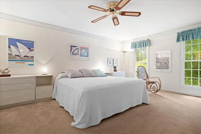 a spacious bedroom with a bed and a window