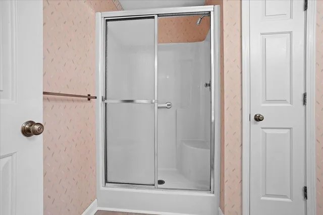 a bathroom with a glass shower door