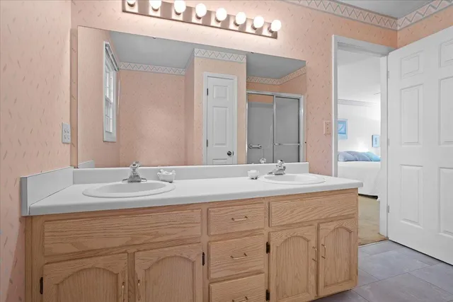 a bathroom with a sink vanity and mirror