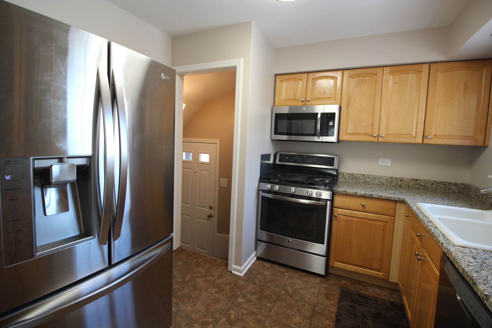5237 North Olcott Avenue Chicago, IL 60656 - Photo 17 of 26 a kitchen with stainless steel appliances granite countertop a refrigerator stove and microwave