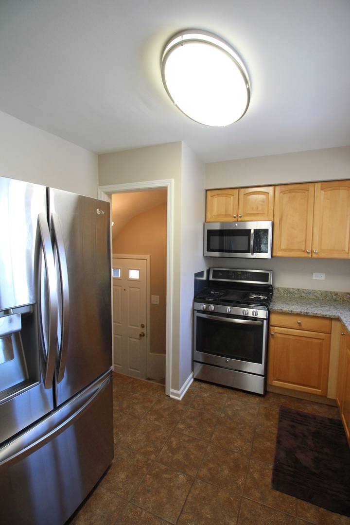 5237 North Olcott Avenue Chicago, IL 60656 - Photo 18 of 26 a view of kitchen with kitchen island a sink stainless steel appliances and cabinets