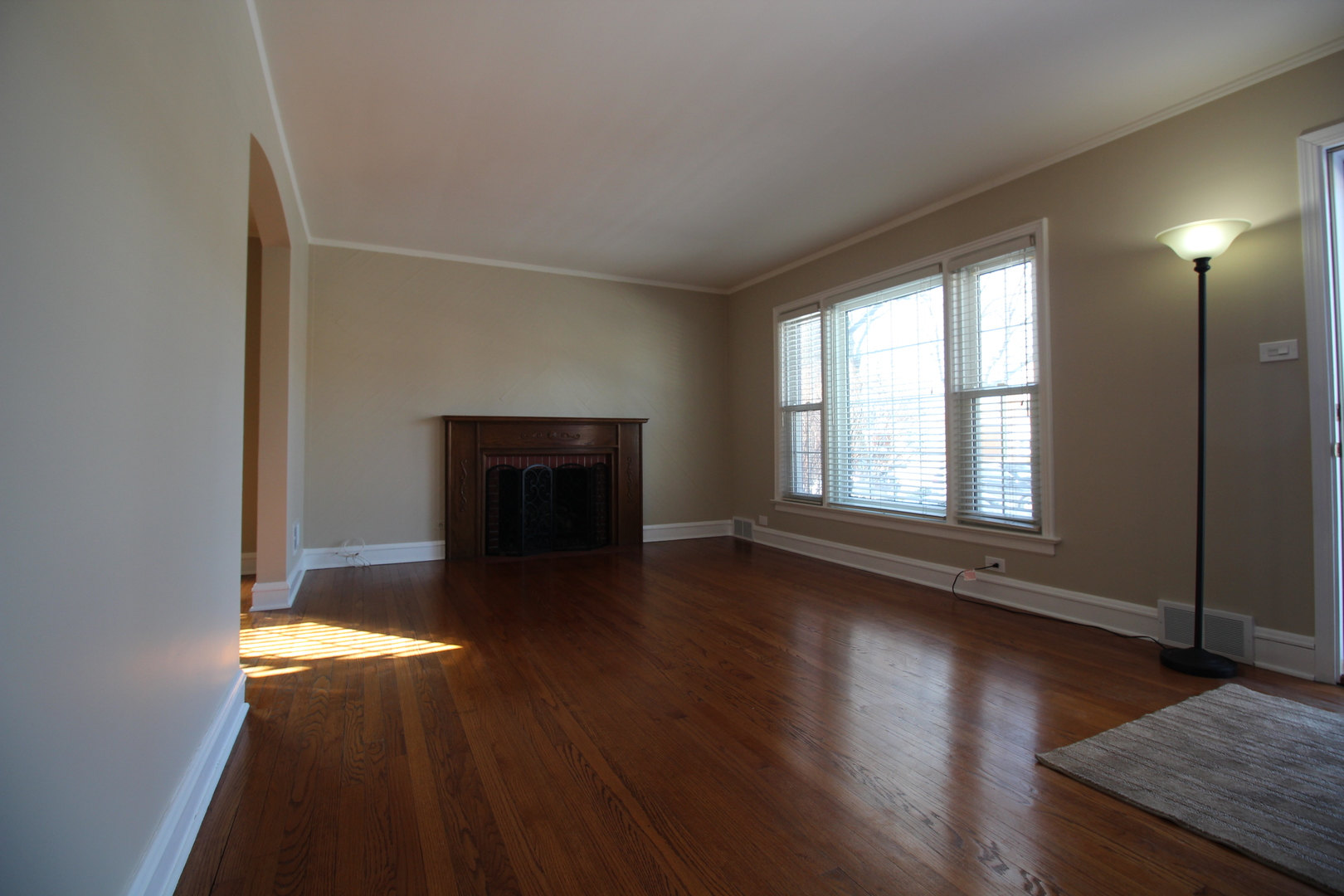 5237 North Olcott Avenue Chicago, IL 60656 - Photo 3 of 26 an empty room with wooden floor fireplace and windows