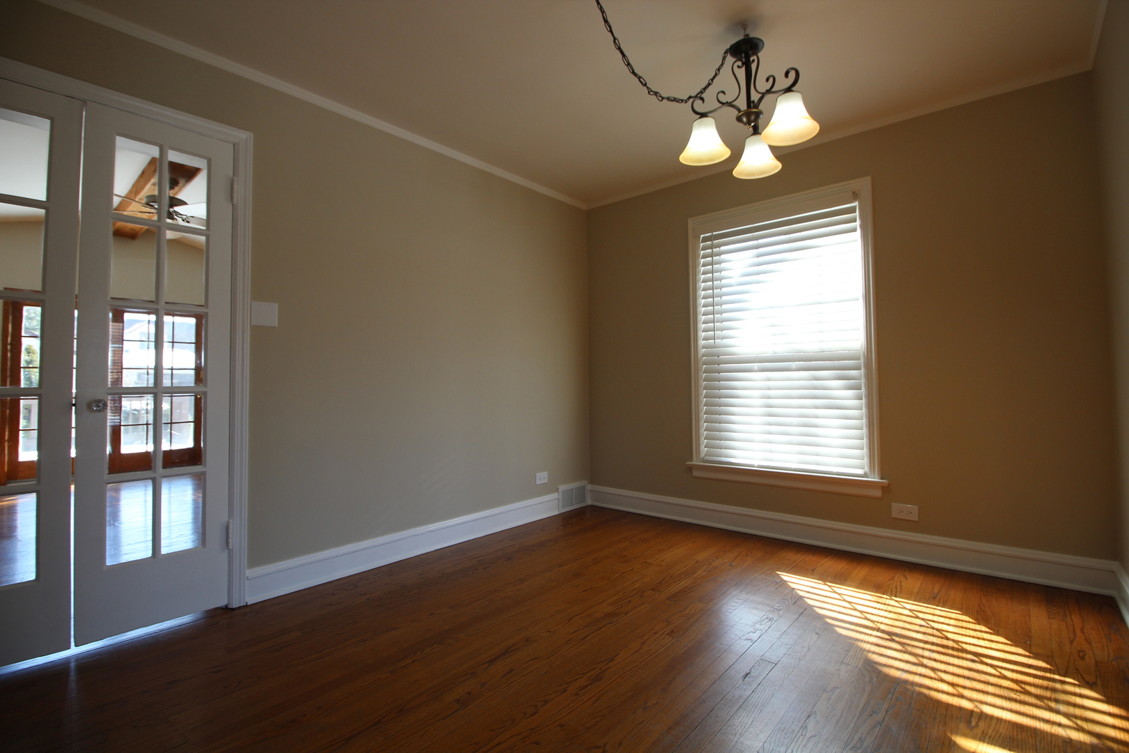 5237 North Olcott Avenue Chicago, IL 60656 - Photo 7 of 26 a view of an empty room with wooden floor and a window