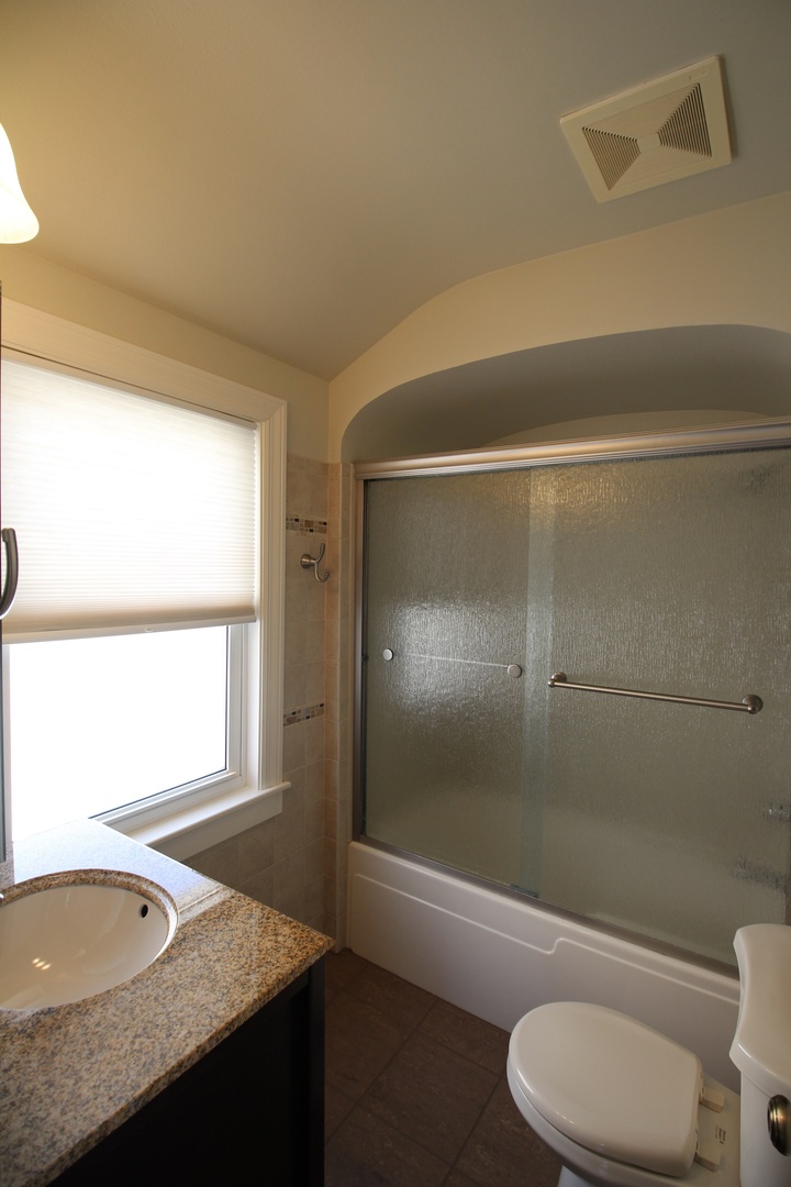 5237 North Olcott Avenue Chicago, IL 60656 - Photo 9 of 26 a bathroom with a granite countertop sink toilet and shower