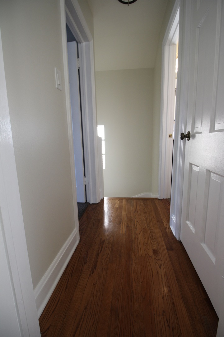 5237 North Olcott Avenue Chicago, IL 60656 - Photo 10 of 26 a view of a hallway with wooden floor