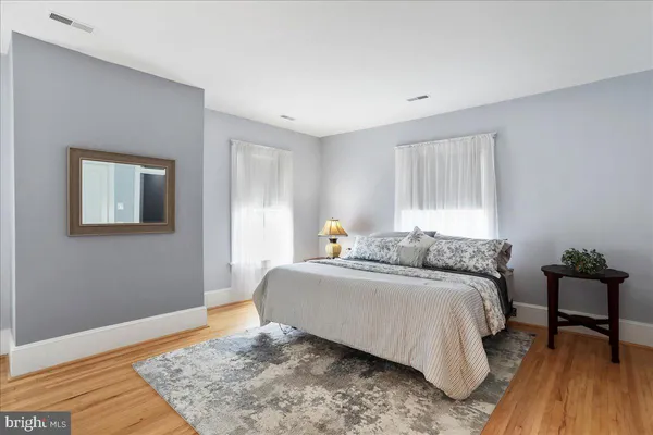 a bedroom with a bed and a couch