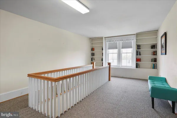 a living room with furniture a rug and a lamp