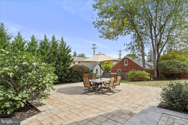 a view of a house with a yard and sitting area