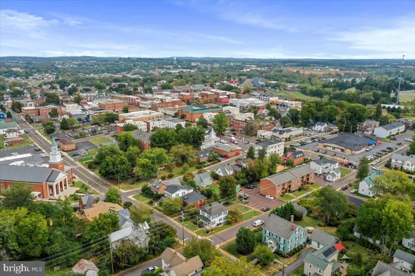a front view of a house with entryway and a rug