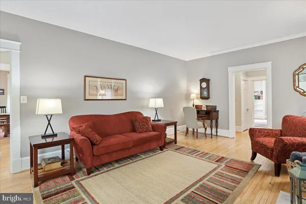 a living room with furniture a lamp and a table