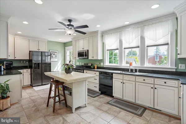 a kitchen with sink cabinets and stainless steel appliances