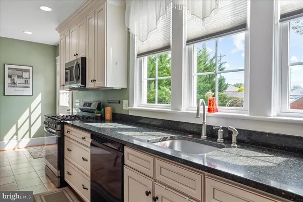 a kitchen with a sink a counter top space and a window