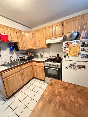 a kitchen with granite countertop a sink stainless steel appliances and cabinets