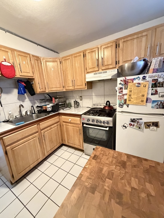 a kitchen with granite countertop a sink stainless steel appliances and cabinets